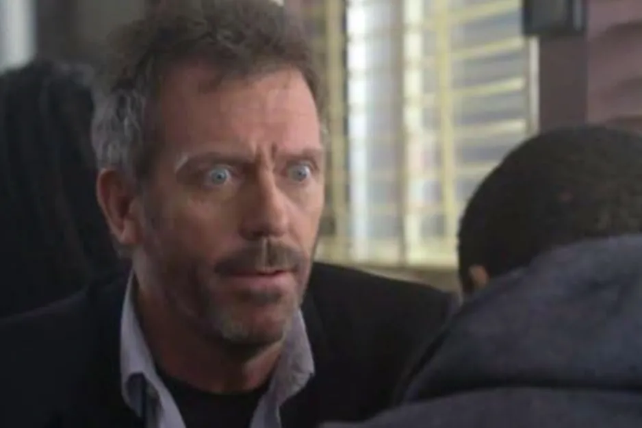 Close-up of a man with intense expression in a medical setting, representing the TV show House, focusing on theme differences.