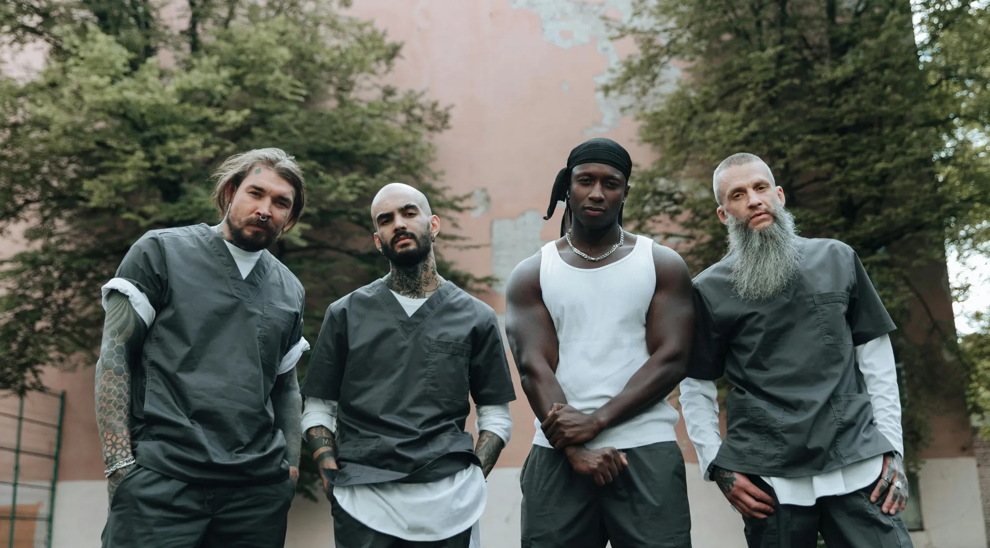 Four men posing outdoors representing gangs, referencing TV shows about gangs in the set.