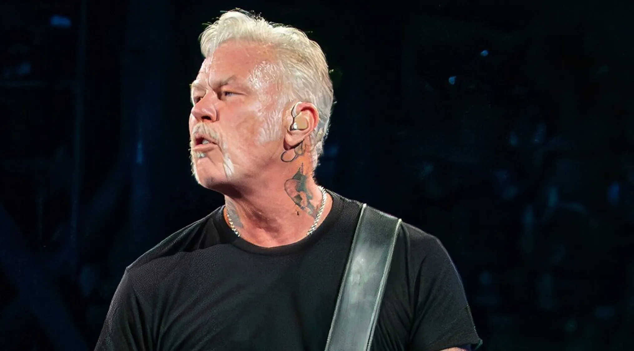 James Hetfield performing live on stage, lead singer and frontman of a famous rock band during a music challenge event.