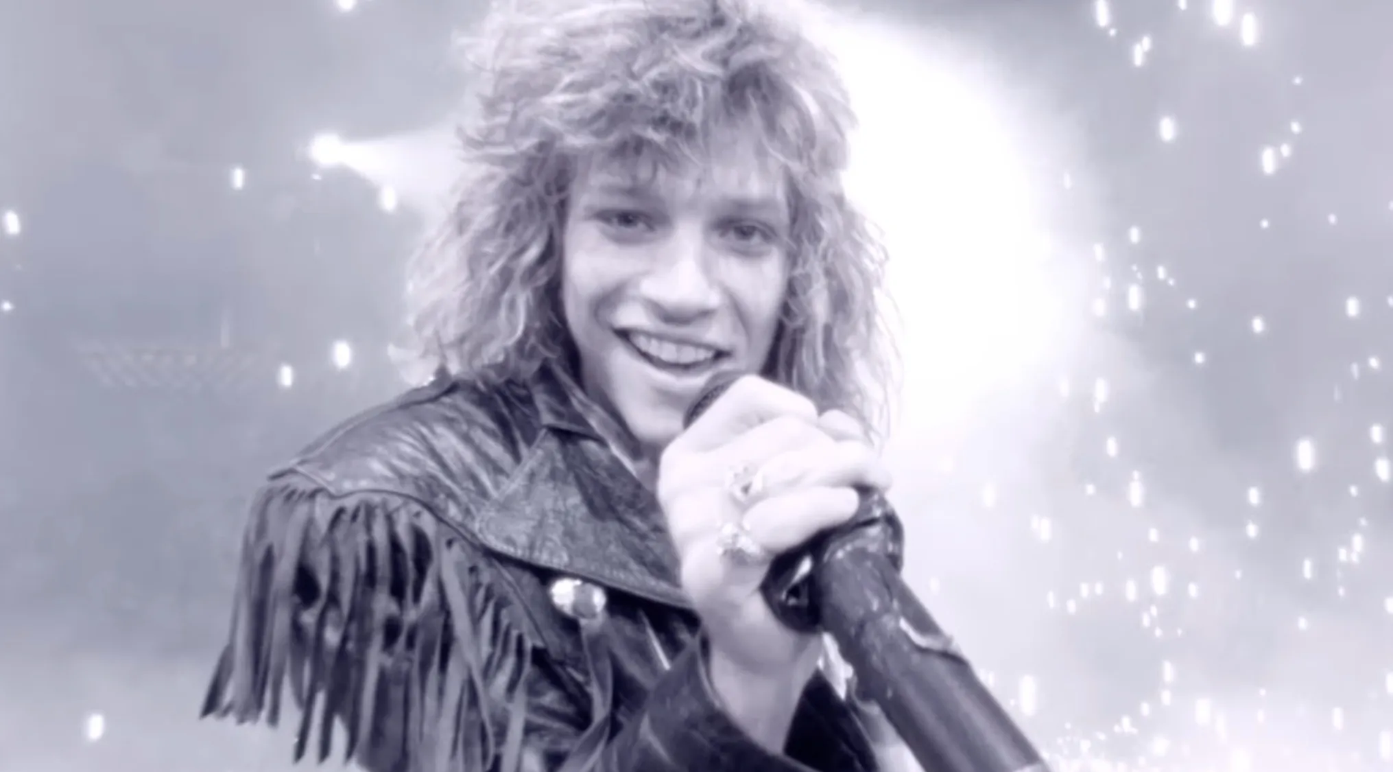 Lead singer performing on stage with microphone, representing music challenge to name 29 bands from the lead singers.
