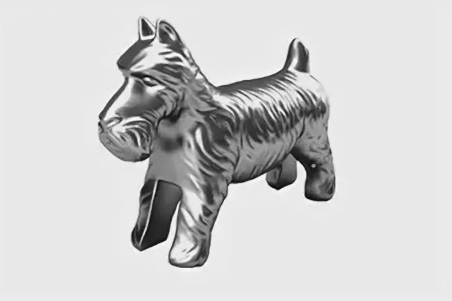 Silver metallic dog Monopoly token in a classic style positioned against a plain white background