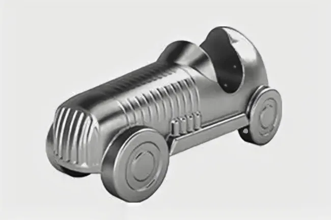 Silver metal car Monopoly token with detailed ridges and wheels, designed as a classic game piece for players.