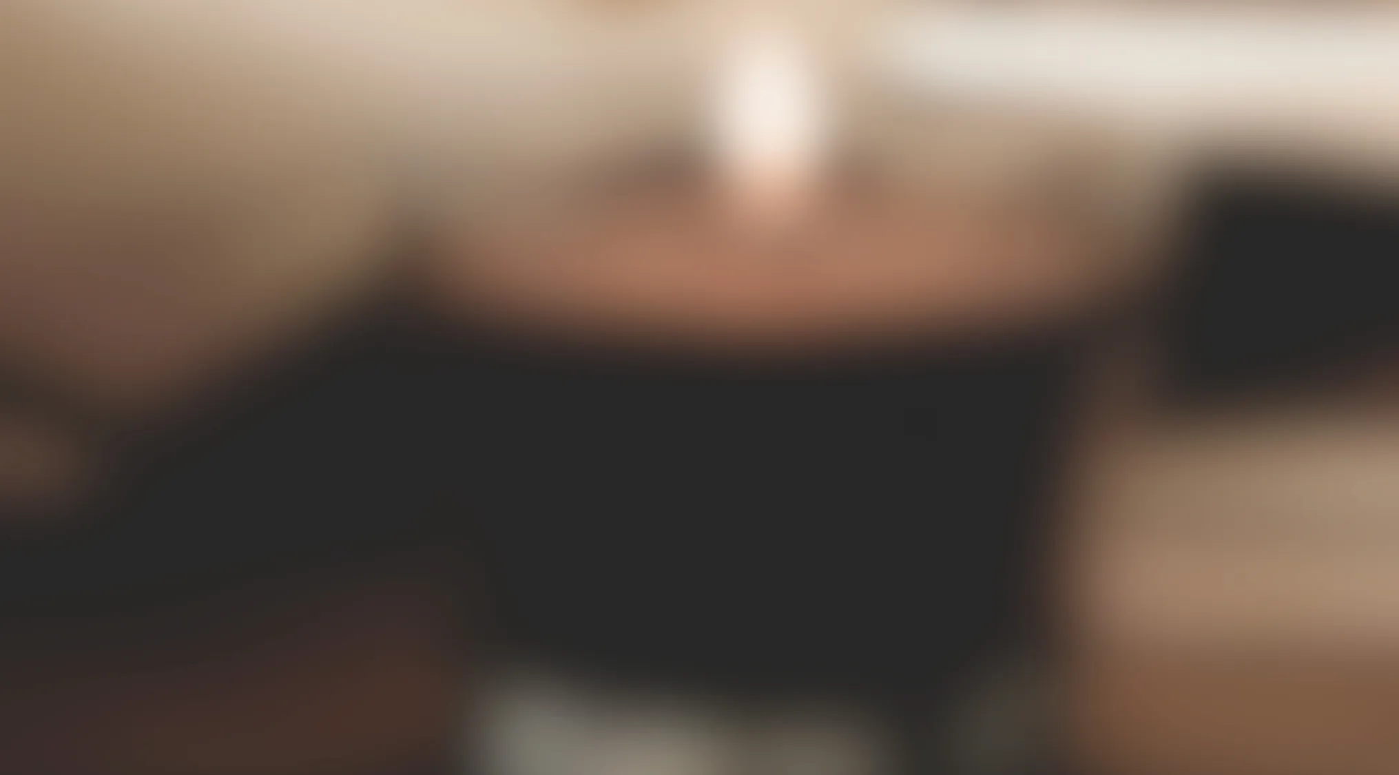 Blurry image of a common household object held in hand, with warm tone background and soft lighting.