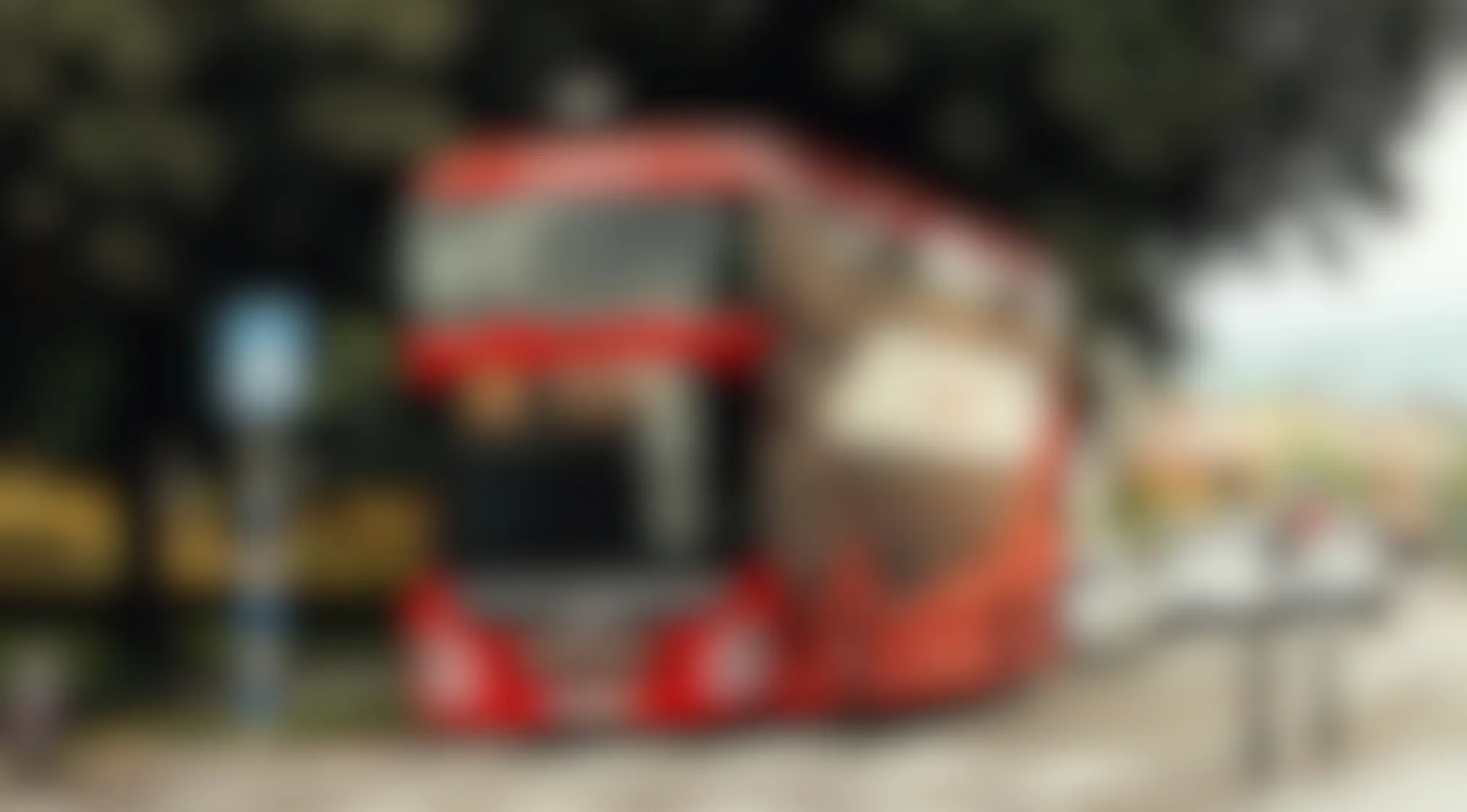 Blurry image showing a red vehicle stopped by the roadside with trees and cars in the background