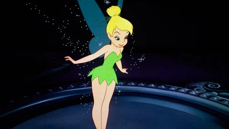 Tinker Bell flying with sparkling fairy dust, wearing a green dress and glowing wings against a dark background.