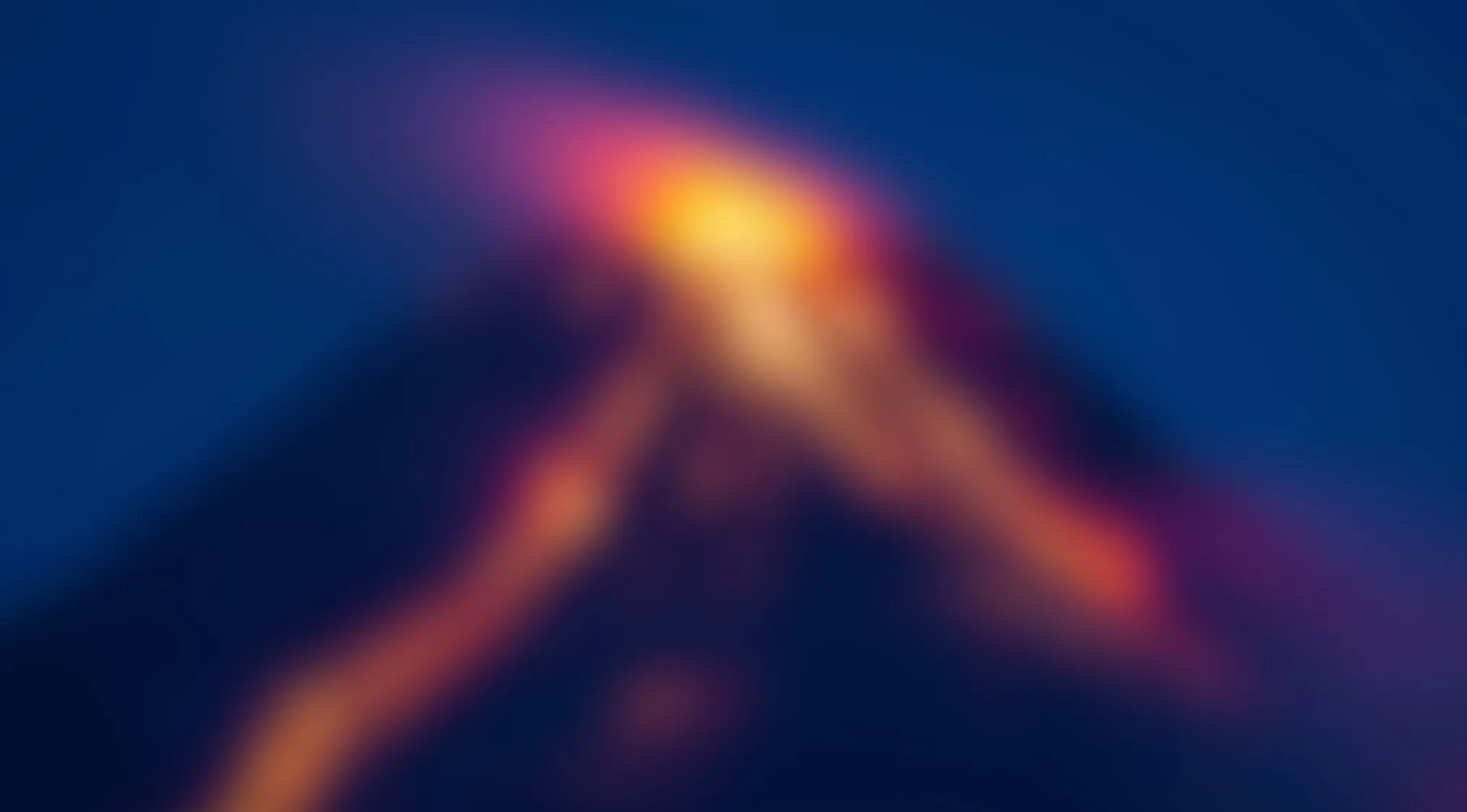 Blurry images showing abstract shapes with warm colors against a dark blue background suggesting hidden details behind the blur