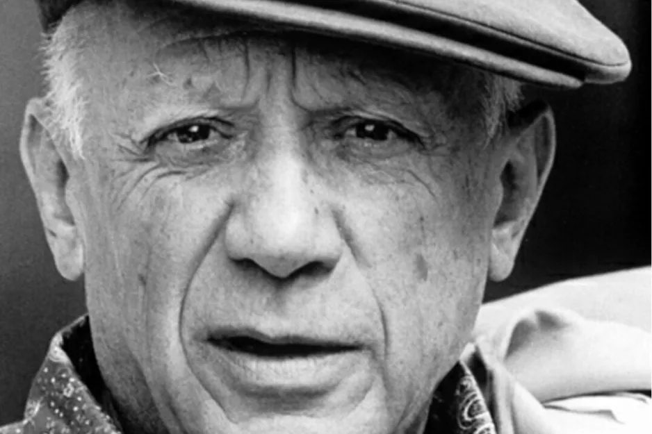Black and white close-up photo of Pablo Picasso wearing a cap, known for Cubism in modern art.