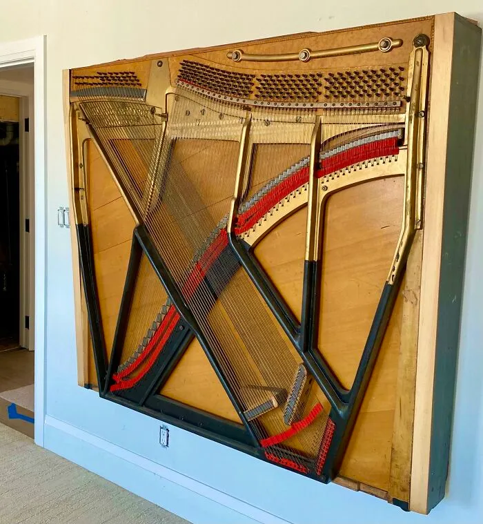 Piano soundboard transformed into surprising artistic wall decor. Creative people turn trash into art.