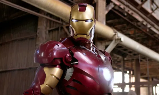 Iron Man superhero mentor standing in an industrial setting, wearing his iconic red and gold armor with glowing eyes.