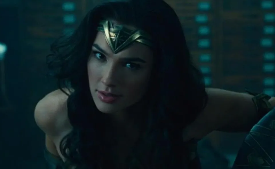 Wonder Woman wearing her iconic armor and tiara, leaning forward with a focused and determined expression.