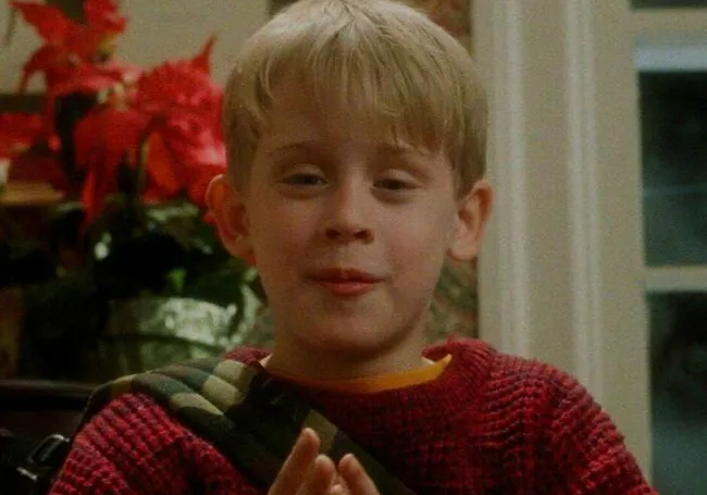 Young boy from Home Alone movie smiling indoors, perfect choice for a family movie night watching together.