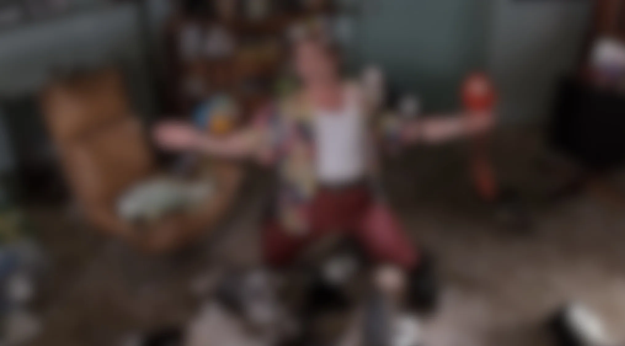 Blurry Movie Scenes: A man in colorful clothes and red pants, arms wide, mid-action. Can you make out this film?