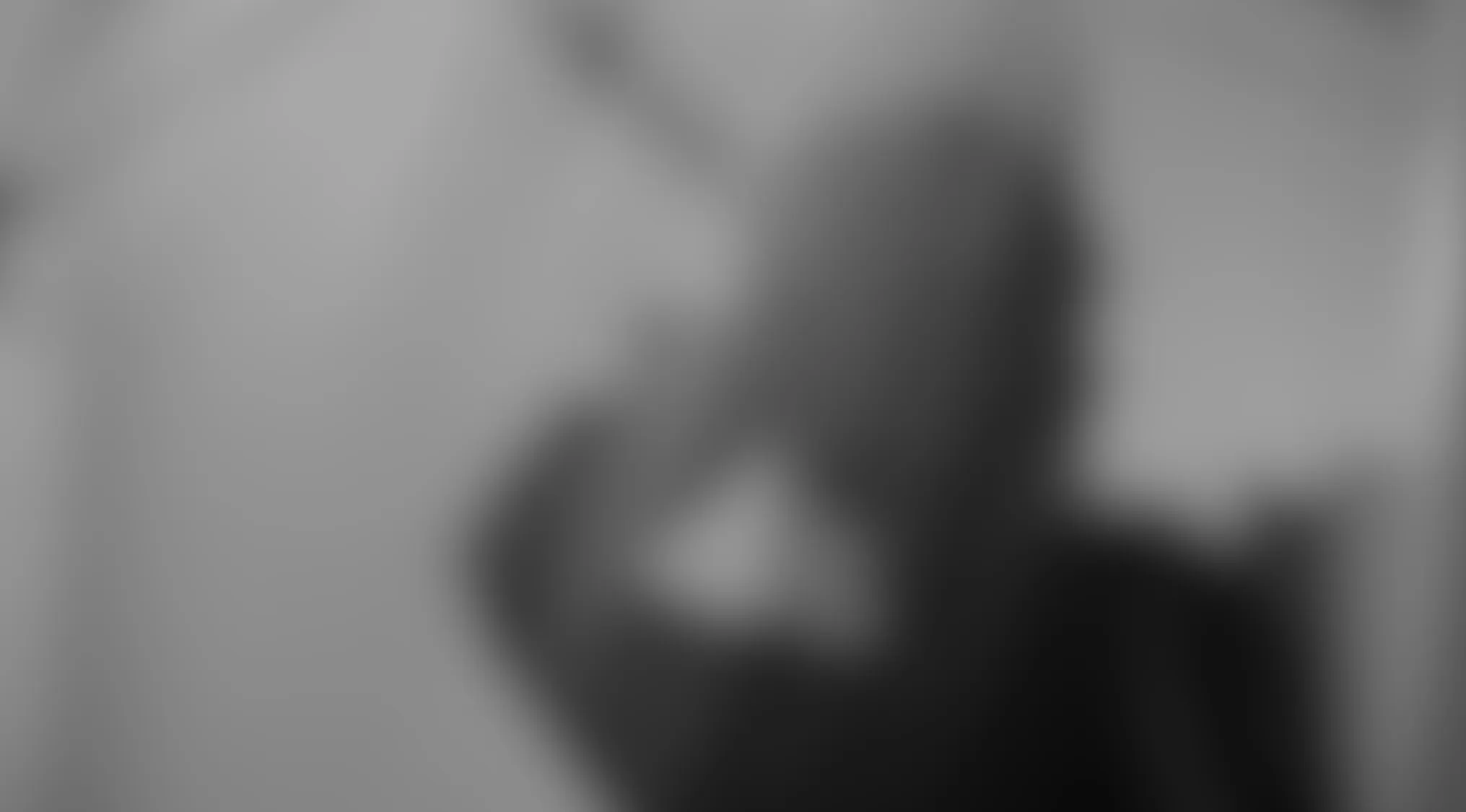 An extremely blurry, grayscale image, challenging viewers to identify this Blurry Movie Scene.