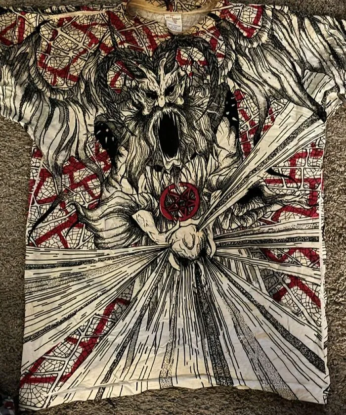 A detailed graphic tee featuring a screaming horned creature. A suspicious find in the Goodwill bins.