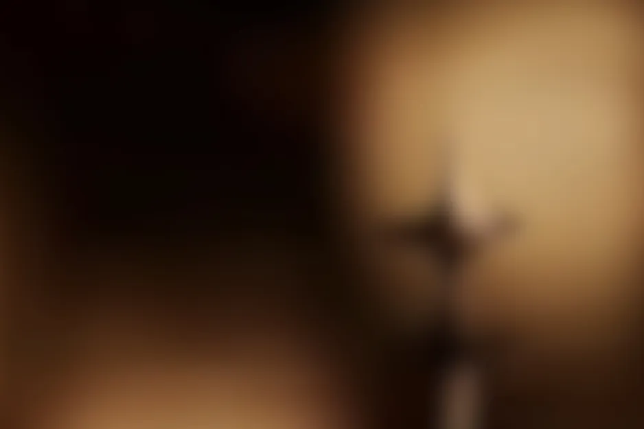 Out-of-focus Inception (2010) scene. Dark and warm brown tones with an abstract, blurry shape.