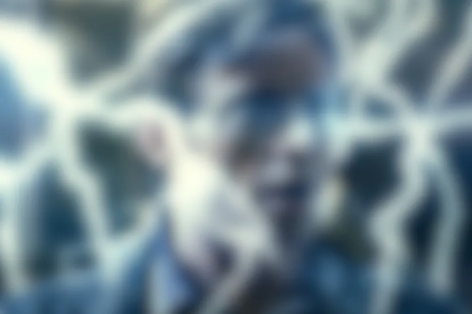 A dark, blurry scene from The Prestige with a figure surrounded by bright, electric-like white and blue glowing energy.