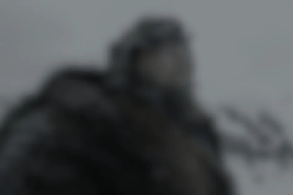 A blurred scene from Catch Me If You Can (2002) depicting a person in winter clothing against a grey, cold backdrop.