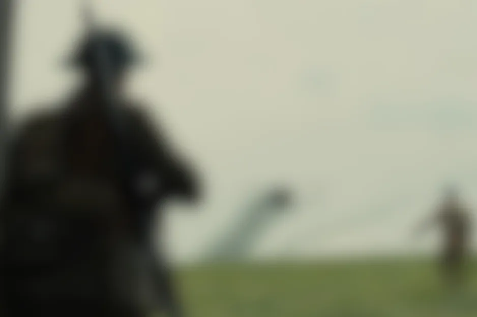 Blurred Saving Private Ryan (1998) scene: silhouettes of soldiers on a battlefield with a distant structure.