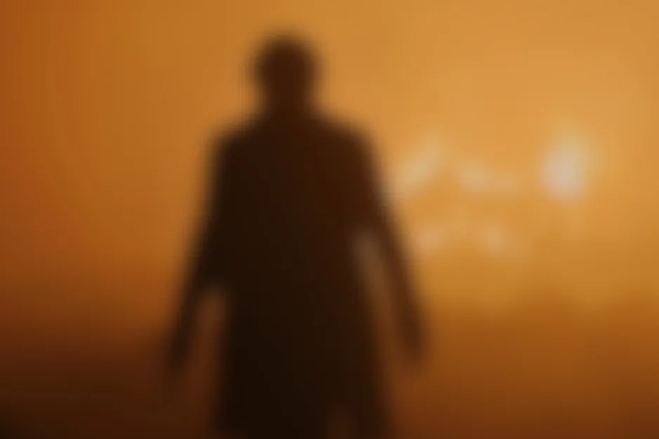 Blurred scene from Skyfall shows a dark, lone figure in an intense orange, hazy landscape.