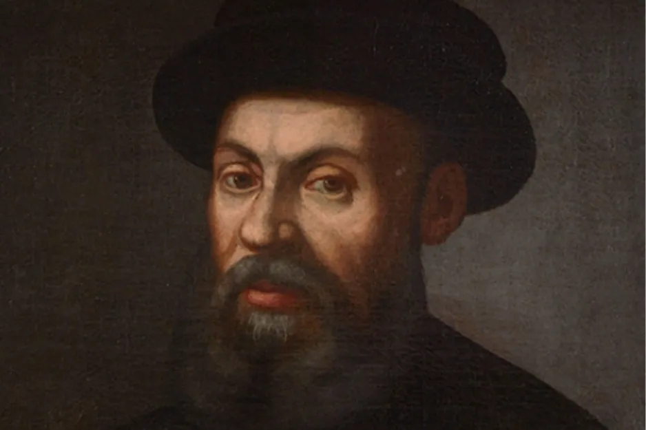 Oil painting of explorer Ferdinand Magellan, who discovered the Pacific Ocean. He has a dark beard and a black hat.