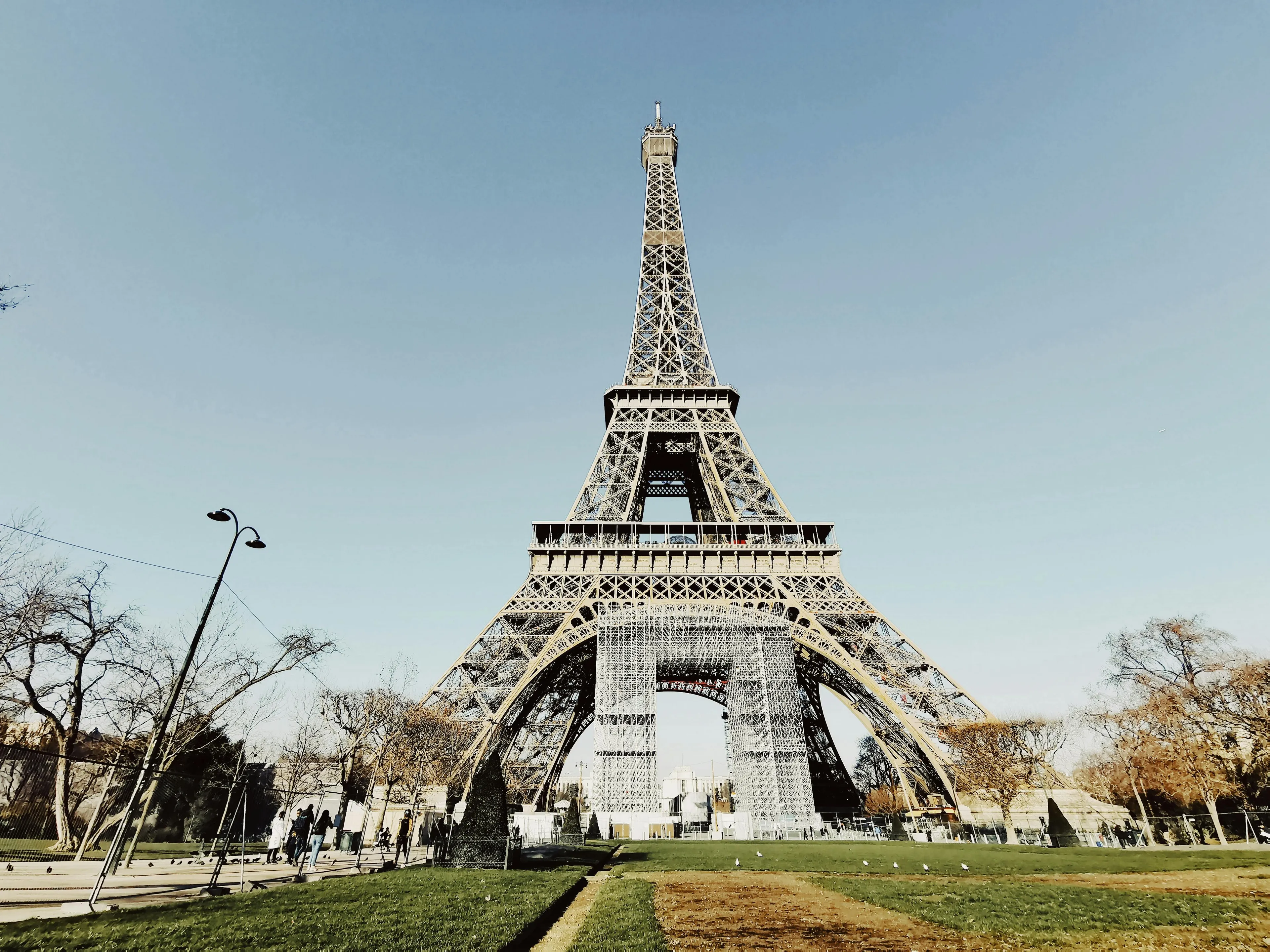 The Eiffel Tower under a clear blue sky. Guess the country from this visual hint and where you can visit this landmark.