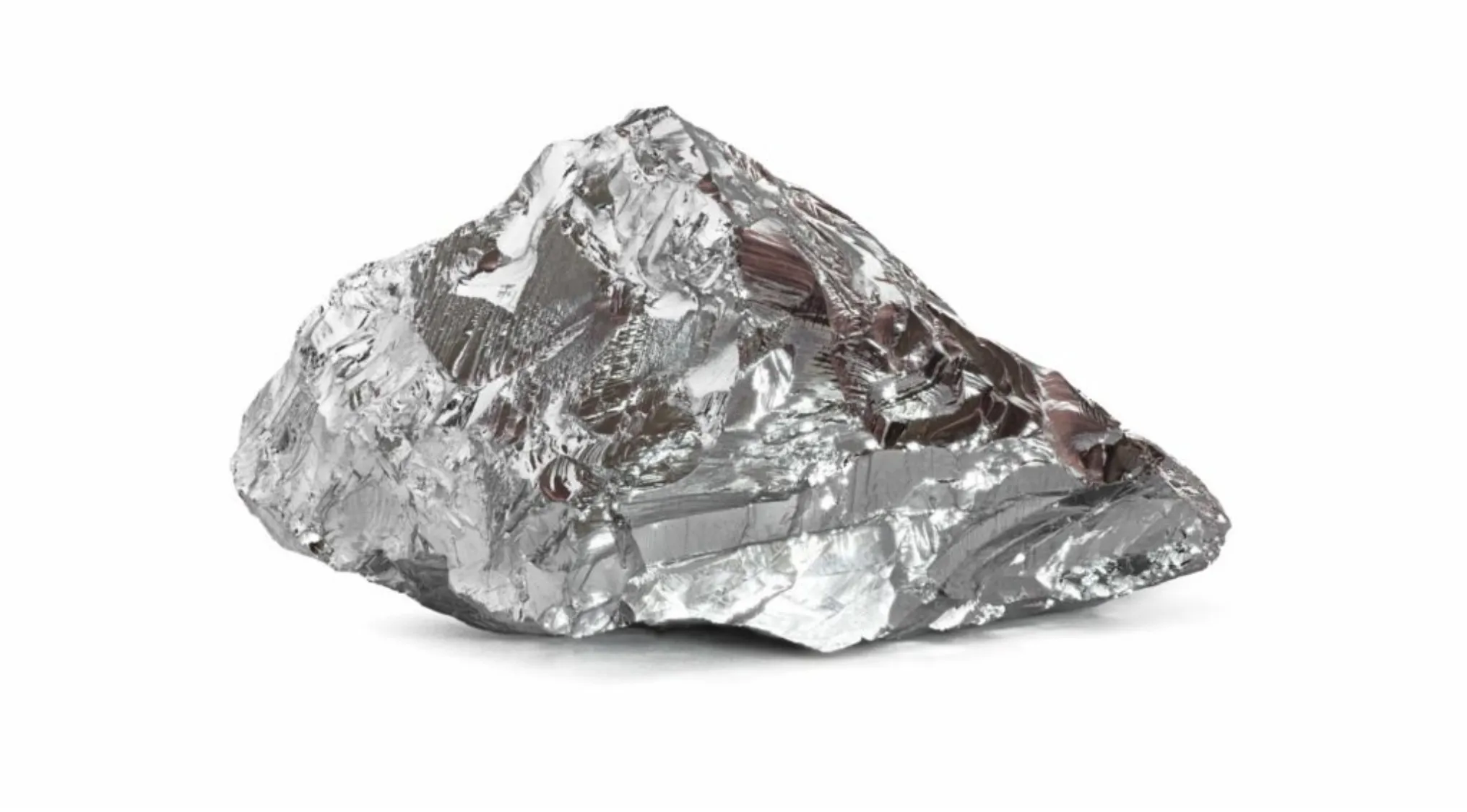 Metallic, shiny mineral crystals, characteristic of nickel ore, against a dark backdrop.
