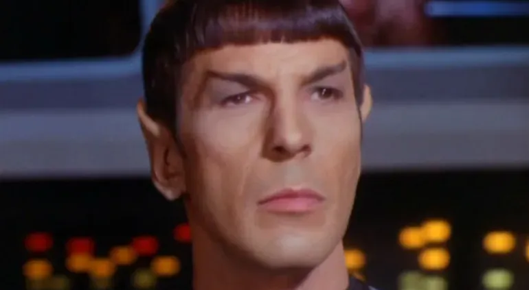 Character in classic movie scene, looking thoughtful and serious, illustrating logic as the beginning of wisdom.
