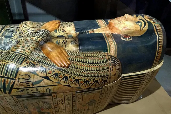 Ancient Egyptian sarcophagus with detailed hieroglyphics and artwork, showcasing historical artifacts and history.