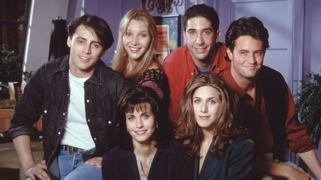 Cast of Friends sitcom posing together in a cozy apartment setting, perfect for a TV show to binge.