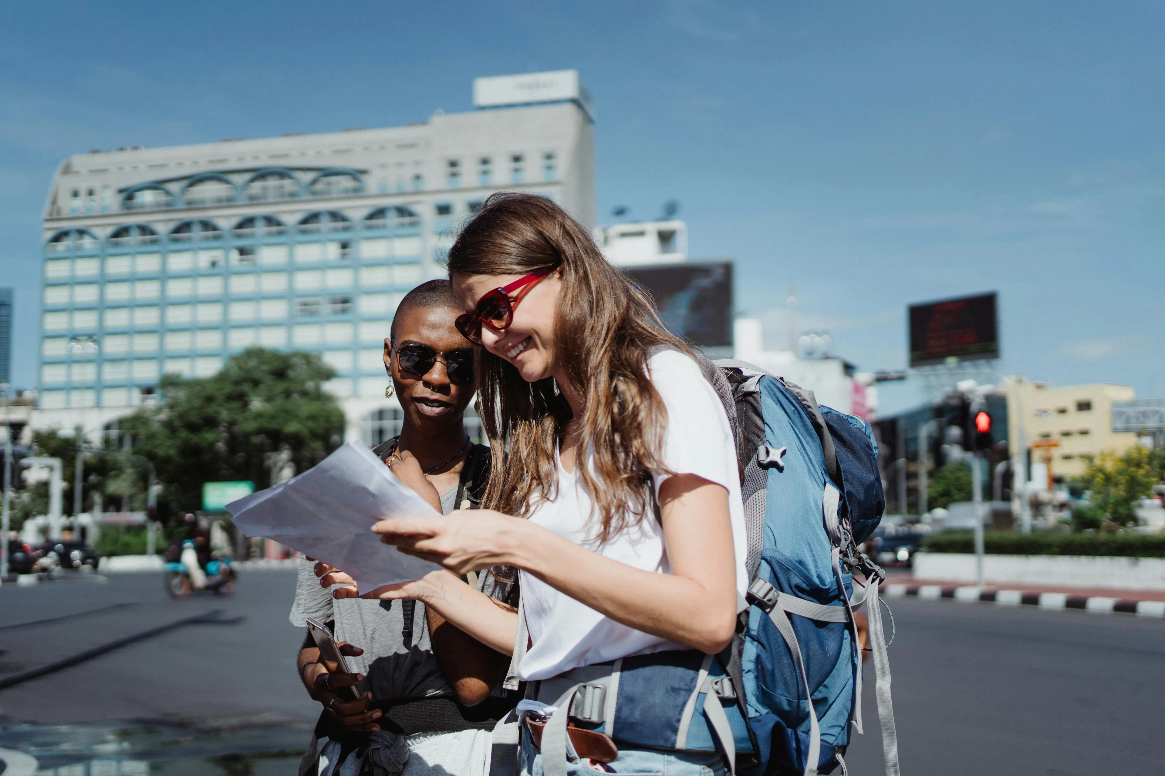 Two travelers with backpacks looking at a map outdoors, exploring traits of left-brain or right-brain companions.