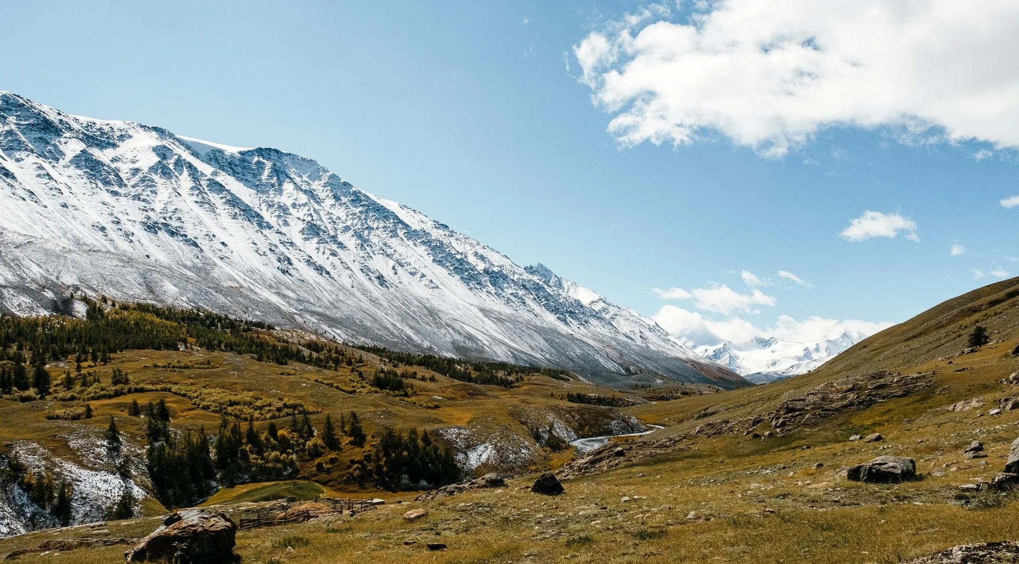 Snow-covered mountain range under blue sky, illustrating geography question about mountains separating Europe and Asia.
