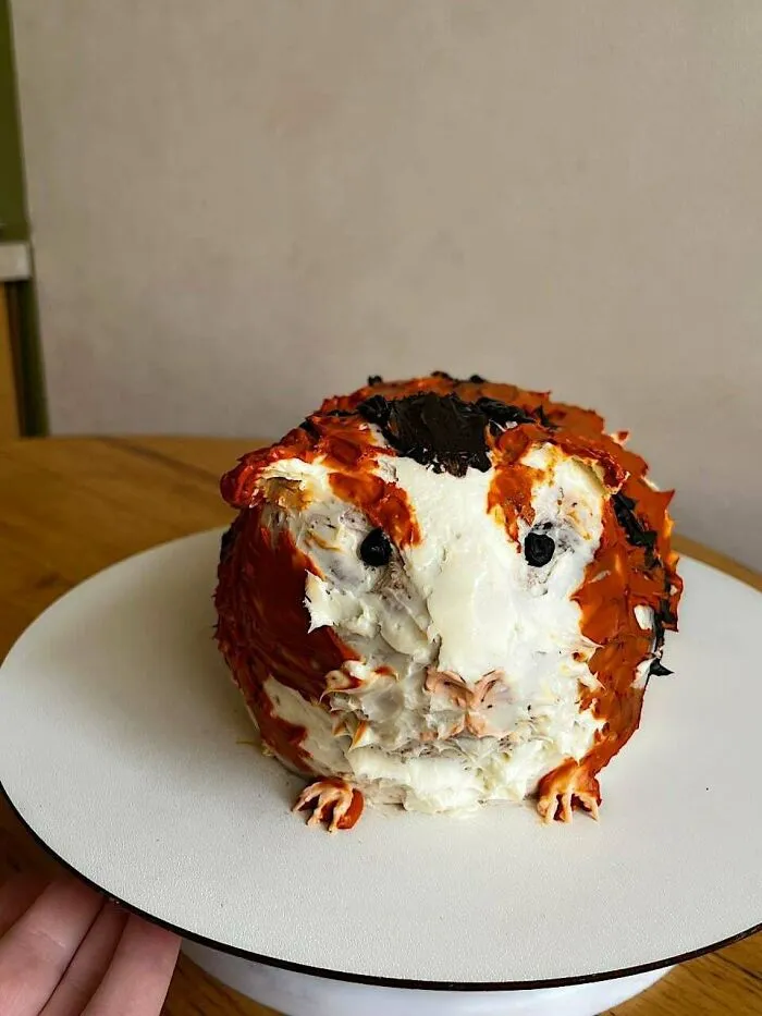 Guinea pig shaped dessert with detailed cream frosting