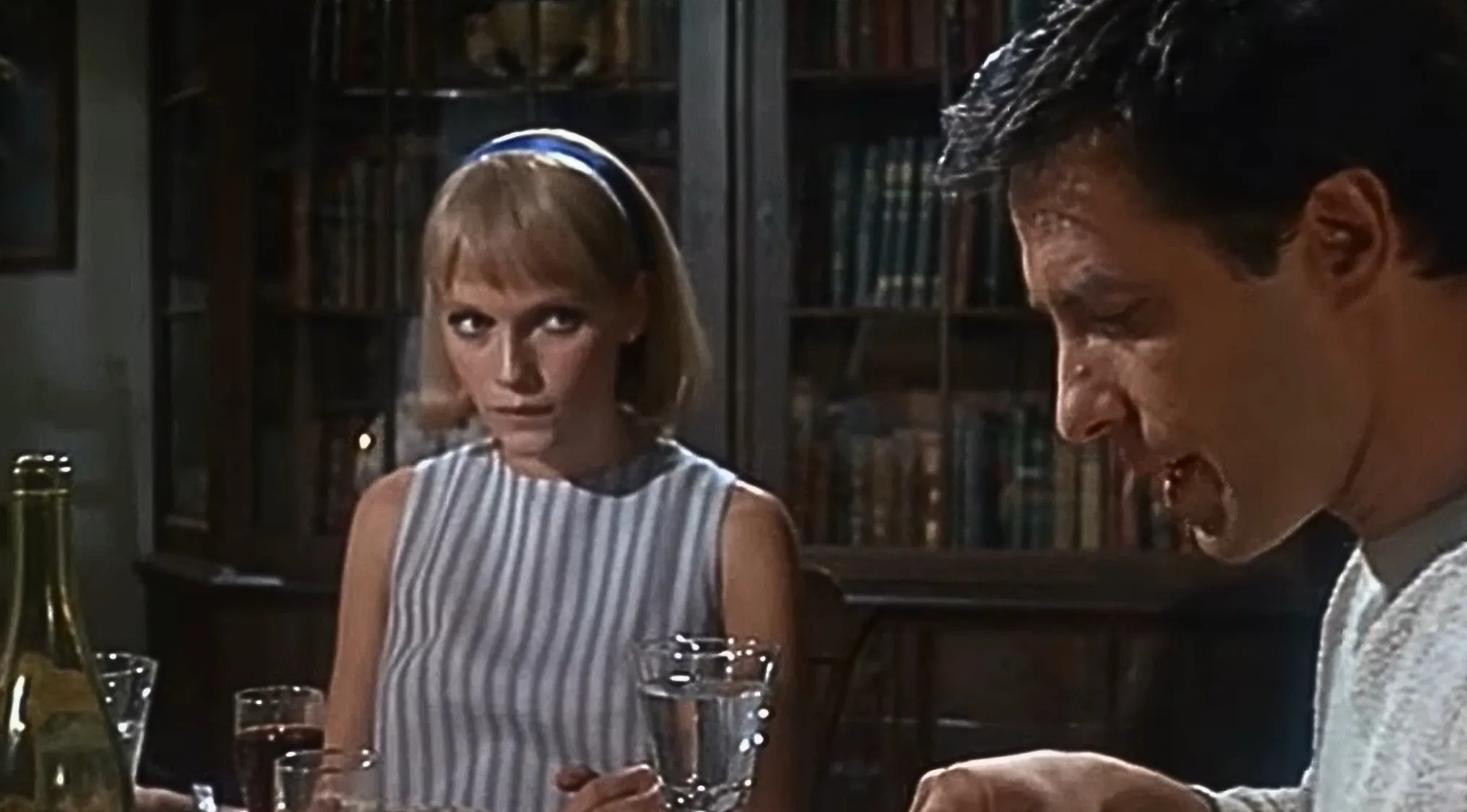 Rosemary Woodhouse, suspicious, watches a man eat. Horror movie trivia from Rosemary's Baby (1968).