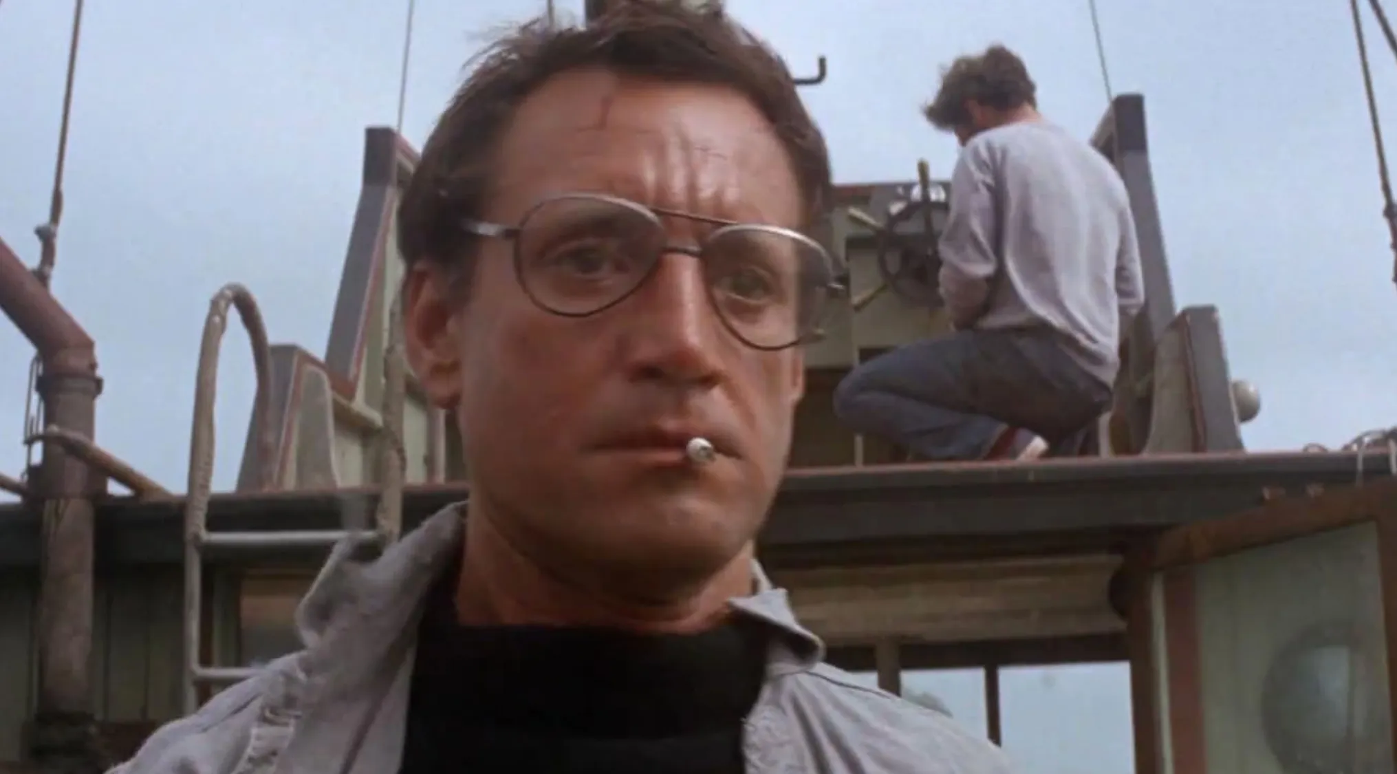 A man with glasses and a cigarette, Robert Shaw, from the Horror Movie Trivia classic Jaws (1975).