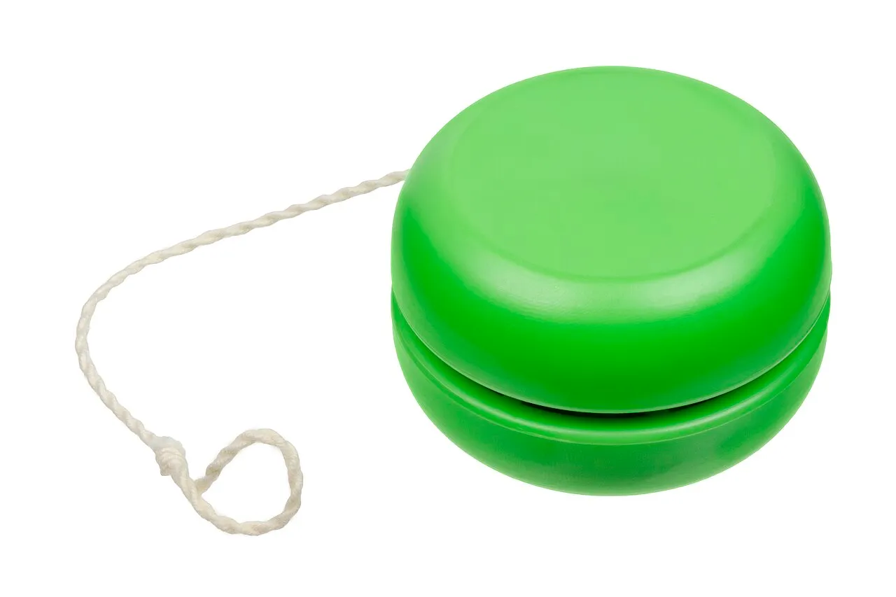 Bright green Yo-Yo with its white string attached, a classic nostalgic toy against a white background.