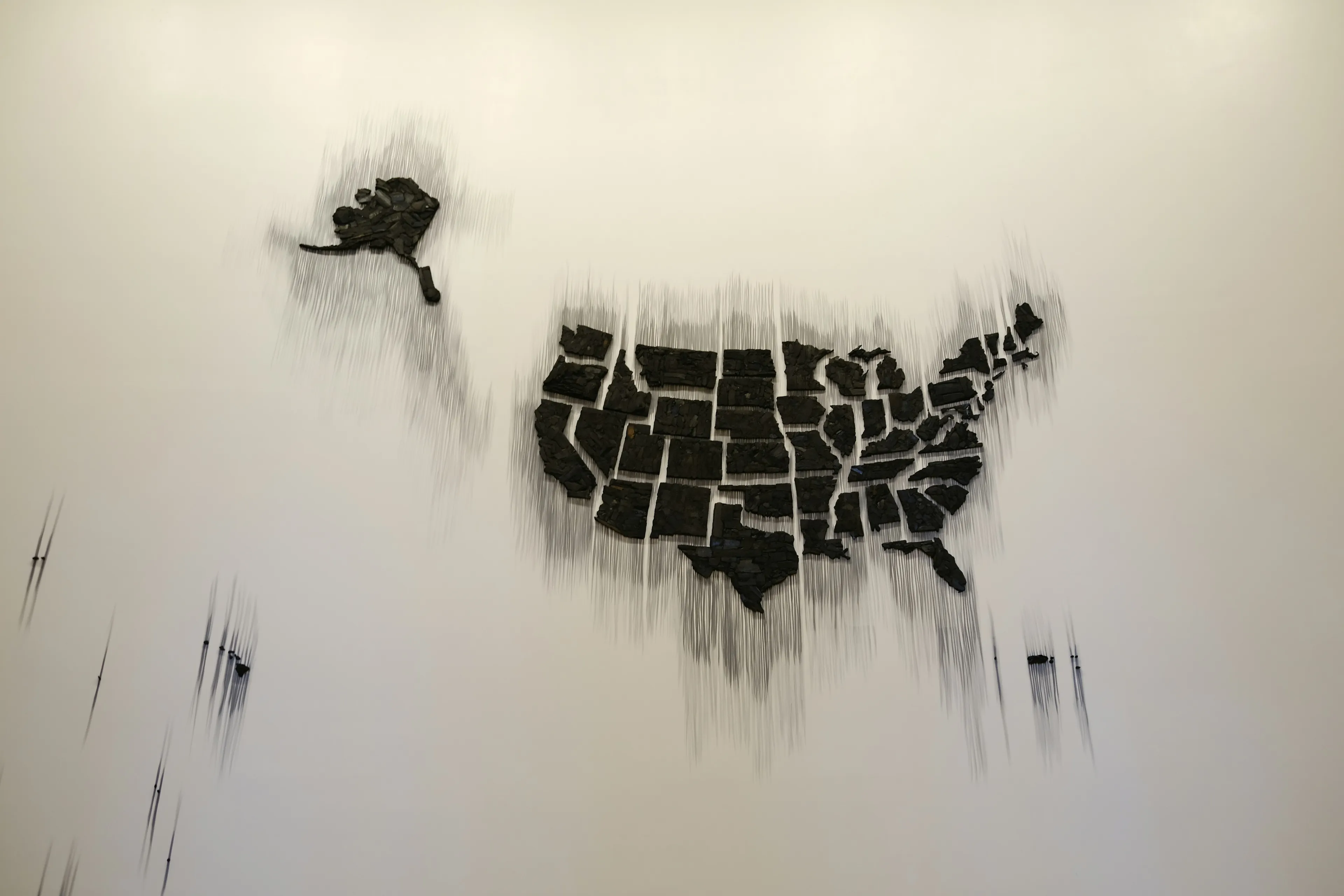 A fractured map of the USA and Alaska on a white background, representing trivia questions like "biggest state in America."