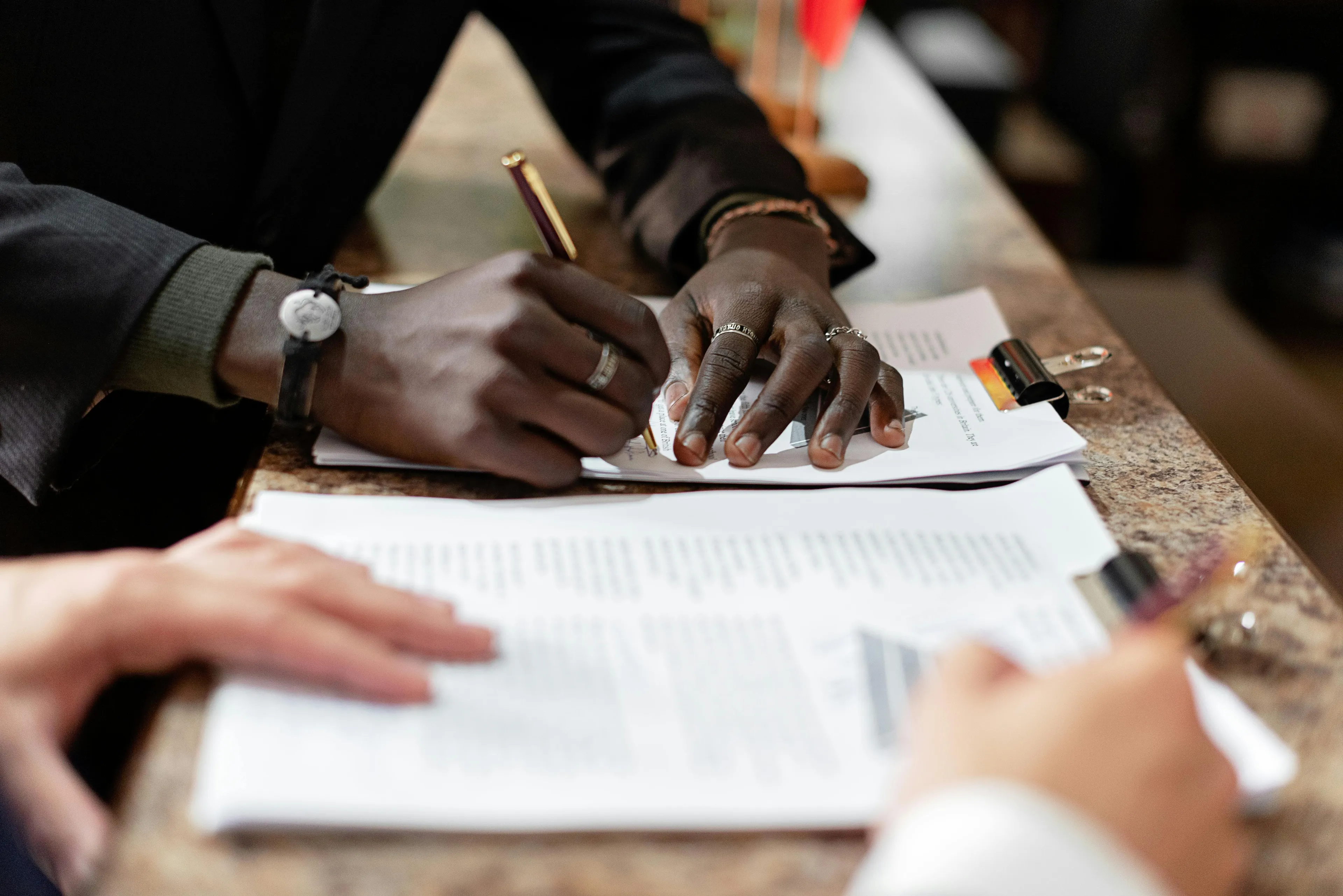 Person signing a document, part of a trivia night question about the Treaty of Versailles. Can you win trivia night?