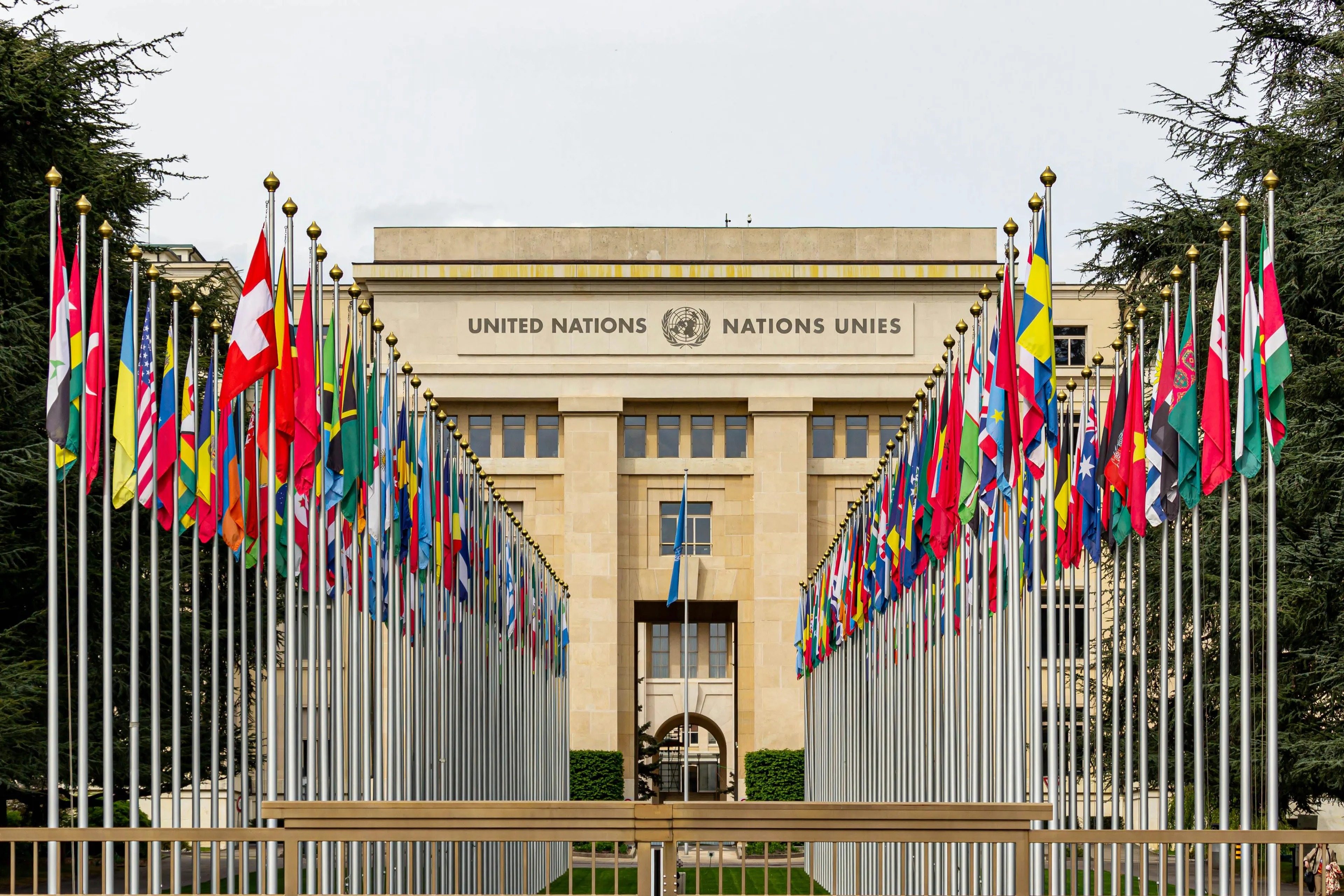 United Nations building flanked by rows of international flags. Can you win trivia night about the UN?