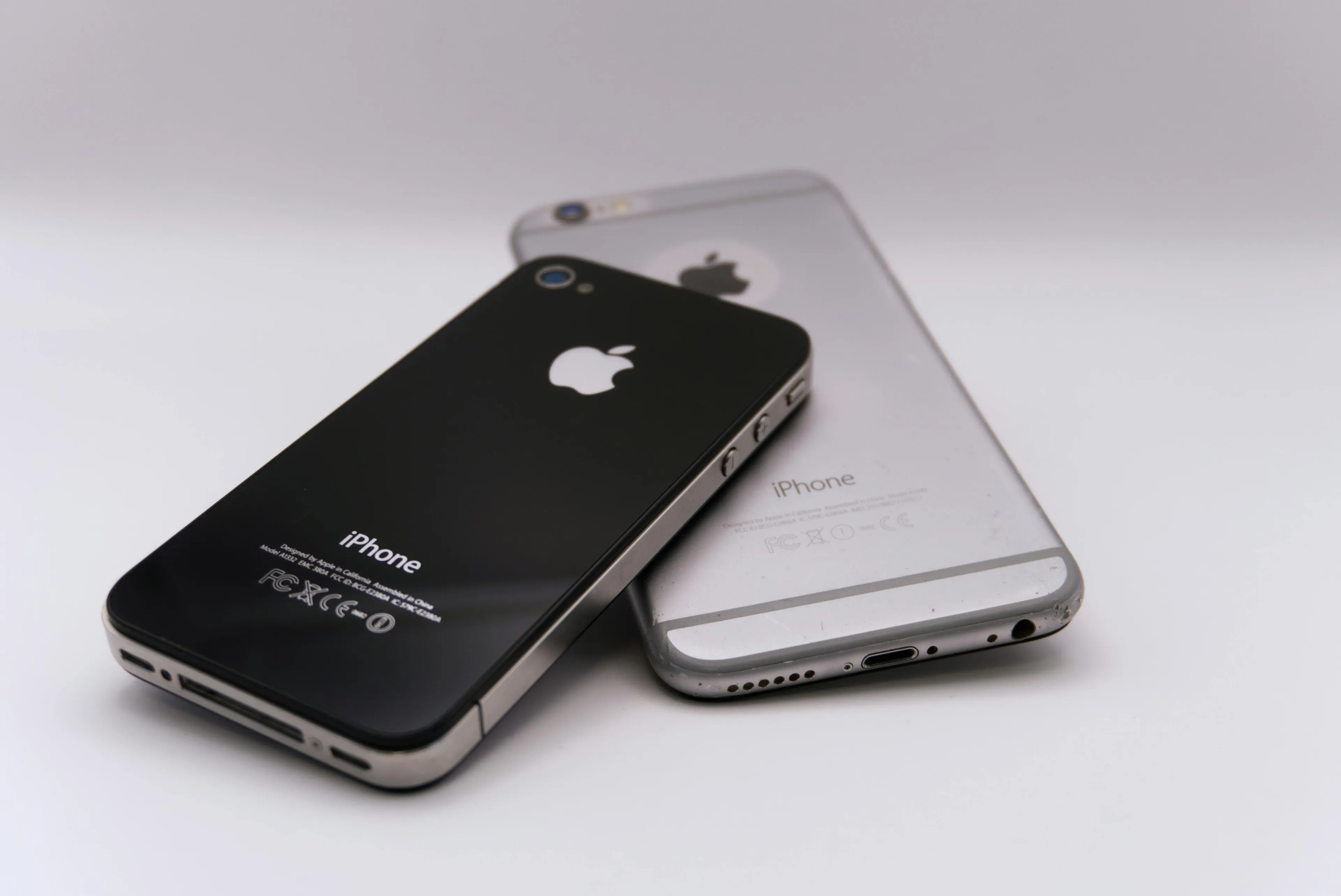 Two generations of iPhones are shown, black and silver. Can you win trivia night? In which year did the first iPhone launch?
