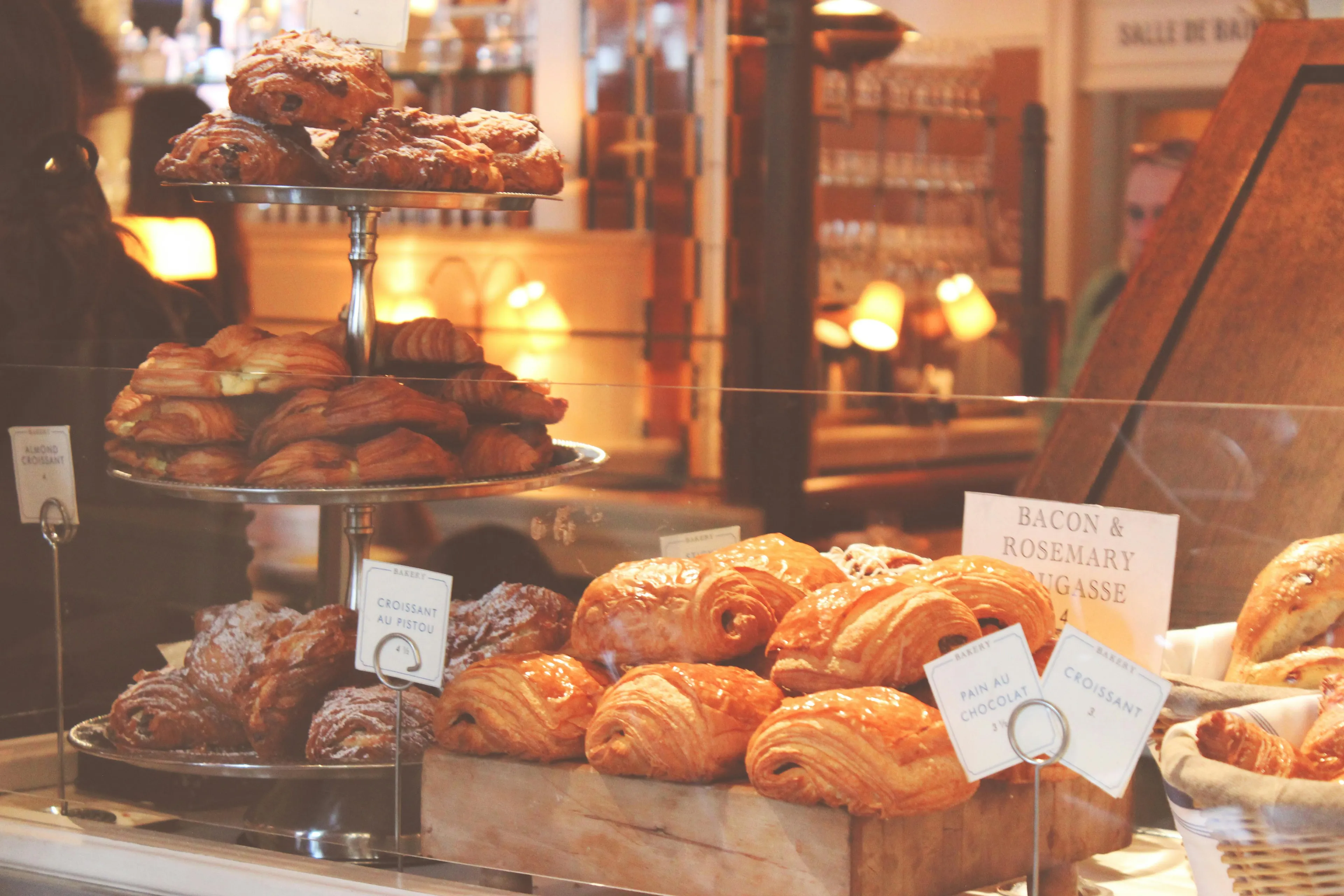 A bakery display filled with pastries: croissants, pain au chocolat, and other baked goods. Reaction to Rejection Quiz pastries.