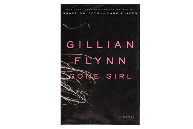 The black cover of Gillian Flynn's novel Gone Girl with pink title text, a great book to reread.