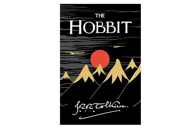 The Hobbit book cover with gold mountains, red sun, and birds, a classic book to reread.