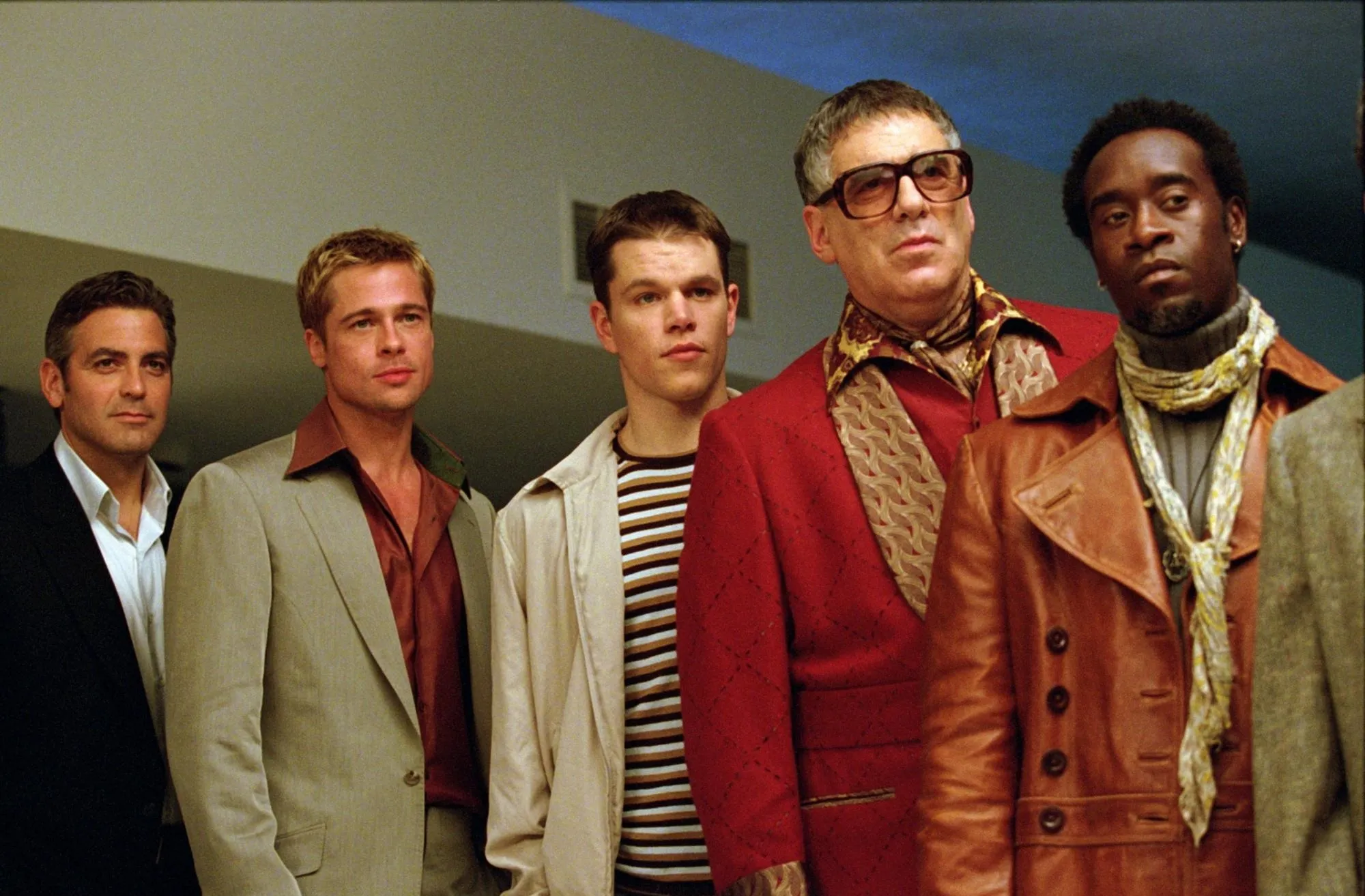 The main cast of Ocean's Eleven, including George Clooney, Brad Pitt, Matt Damon, and Don Cheadle, looking intently.