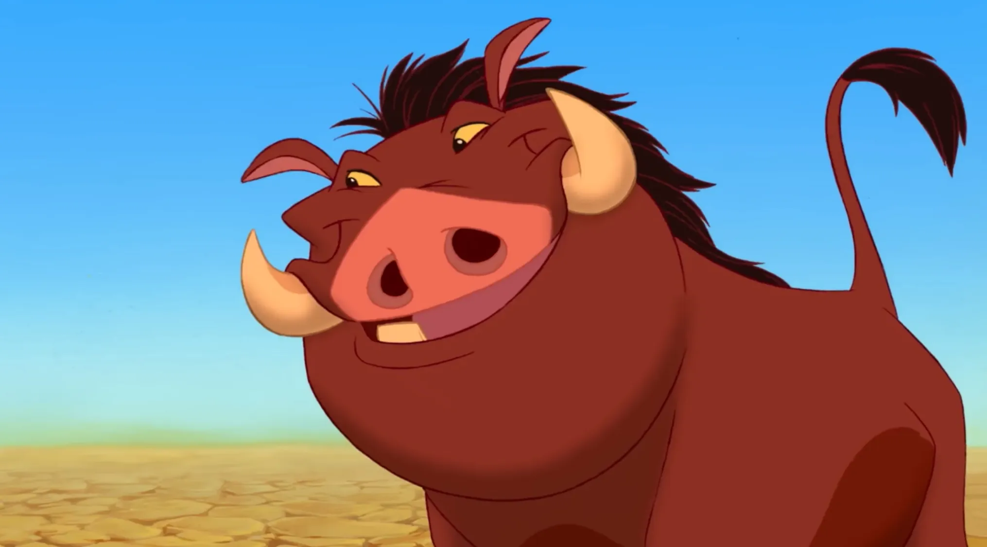 The animated character Pumbaa, a warthog from The Lion King, smiles for a movie quiz question.