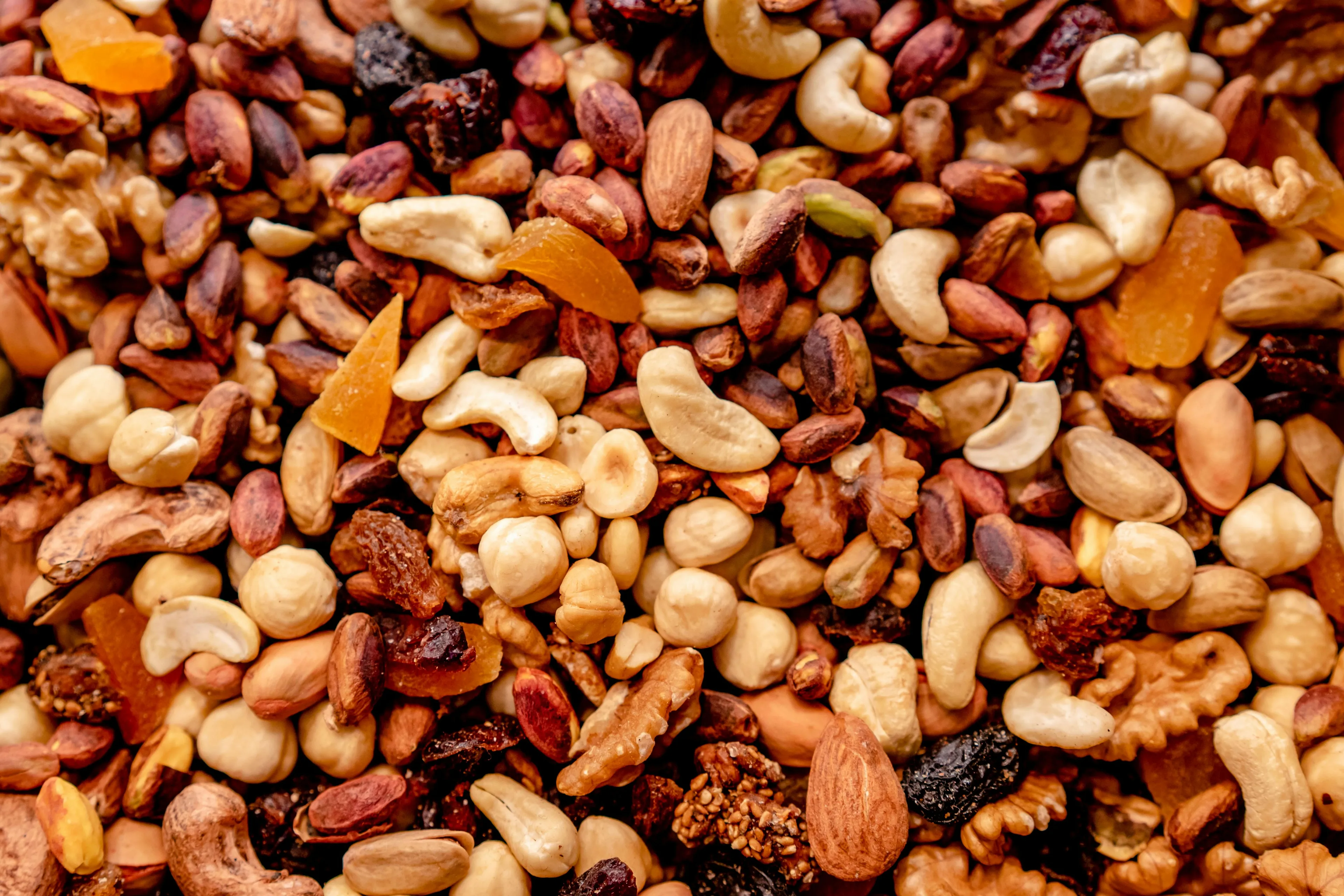 A close-up of a delicious trail mix, featuring a colorful blend of nuts, dried fruits, and seeds. A favorite comfort snack.