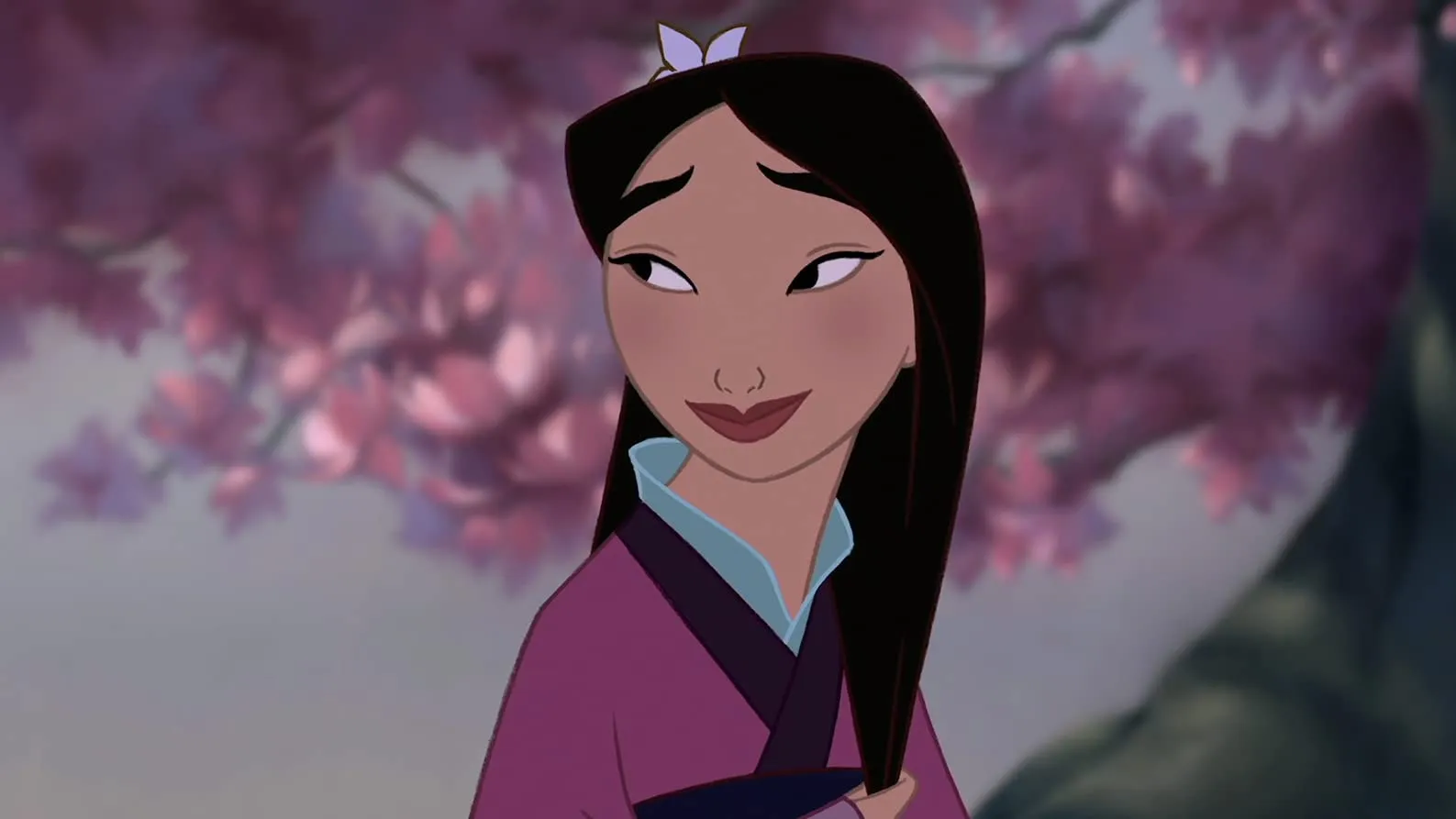 A smiling cartoon depiction of Mulan, with long dark hair and a light purple flower, wearing a purple and blue outfit, with pink flowering trees in the background.
