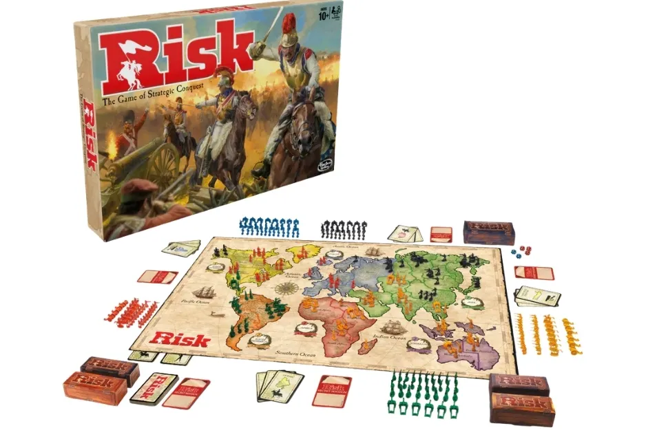 A complete Risk board game set with box, world map board, colorful armies, cards, and dice.