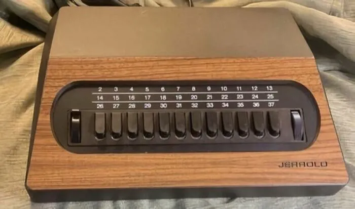 An old Jerrold cable box with a wooden grain finish and numbered channel buttons, a trip down memory lane.