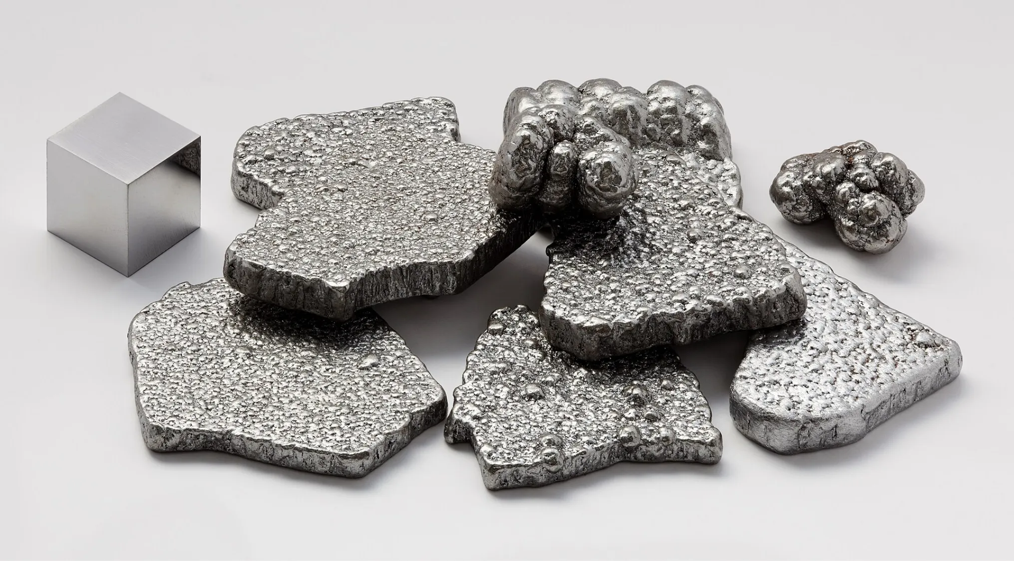 Various forms of raw iron, including a smooth cube and textured ingots. A General Knowledge question about the Latin name for iron.