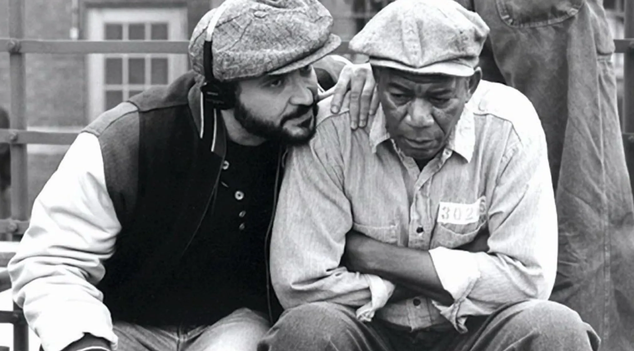 Guess The Movie: BTS image shows director and Morgan Freeman on set, the film star looking distraught.